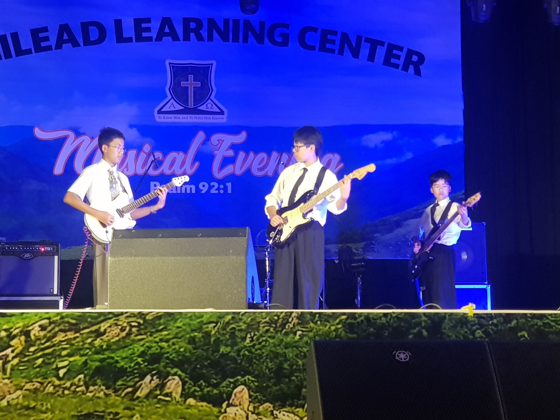 GLC Shillong students performing with electric guitars on stage